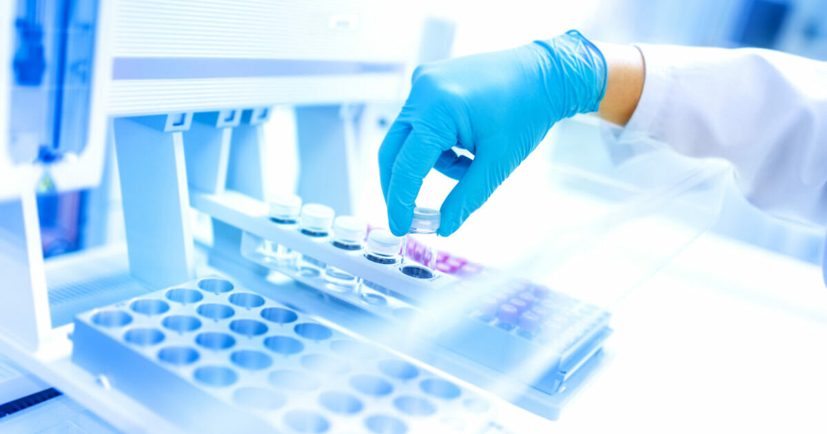 Scientist using protective robber gloves for handling dangerous substances and experiments